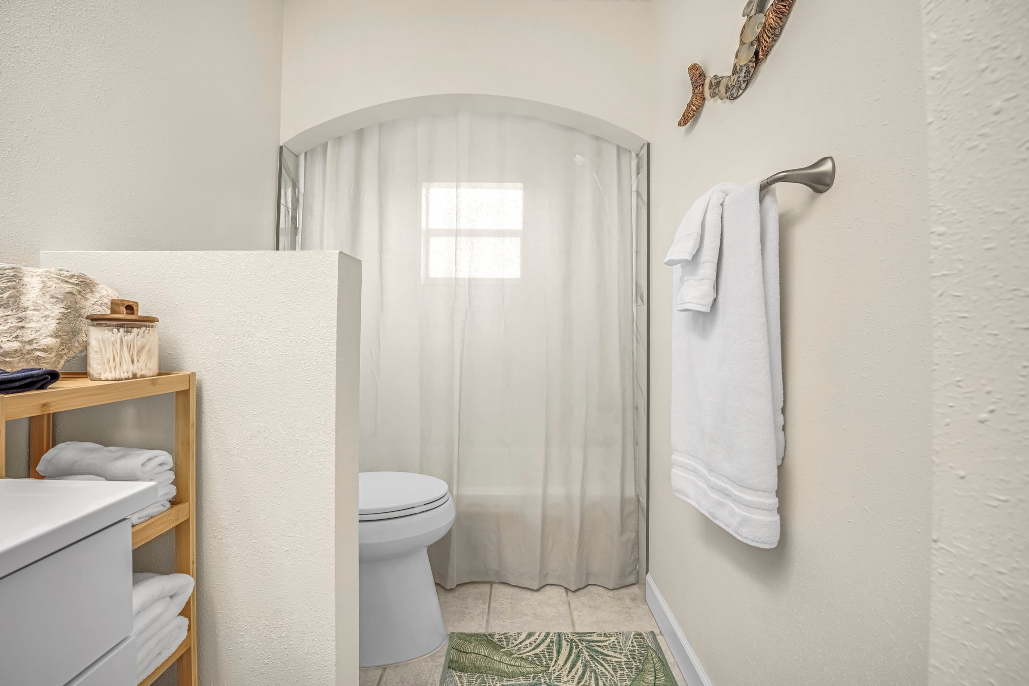 Bathroom with coastal vanity and shower