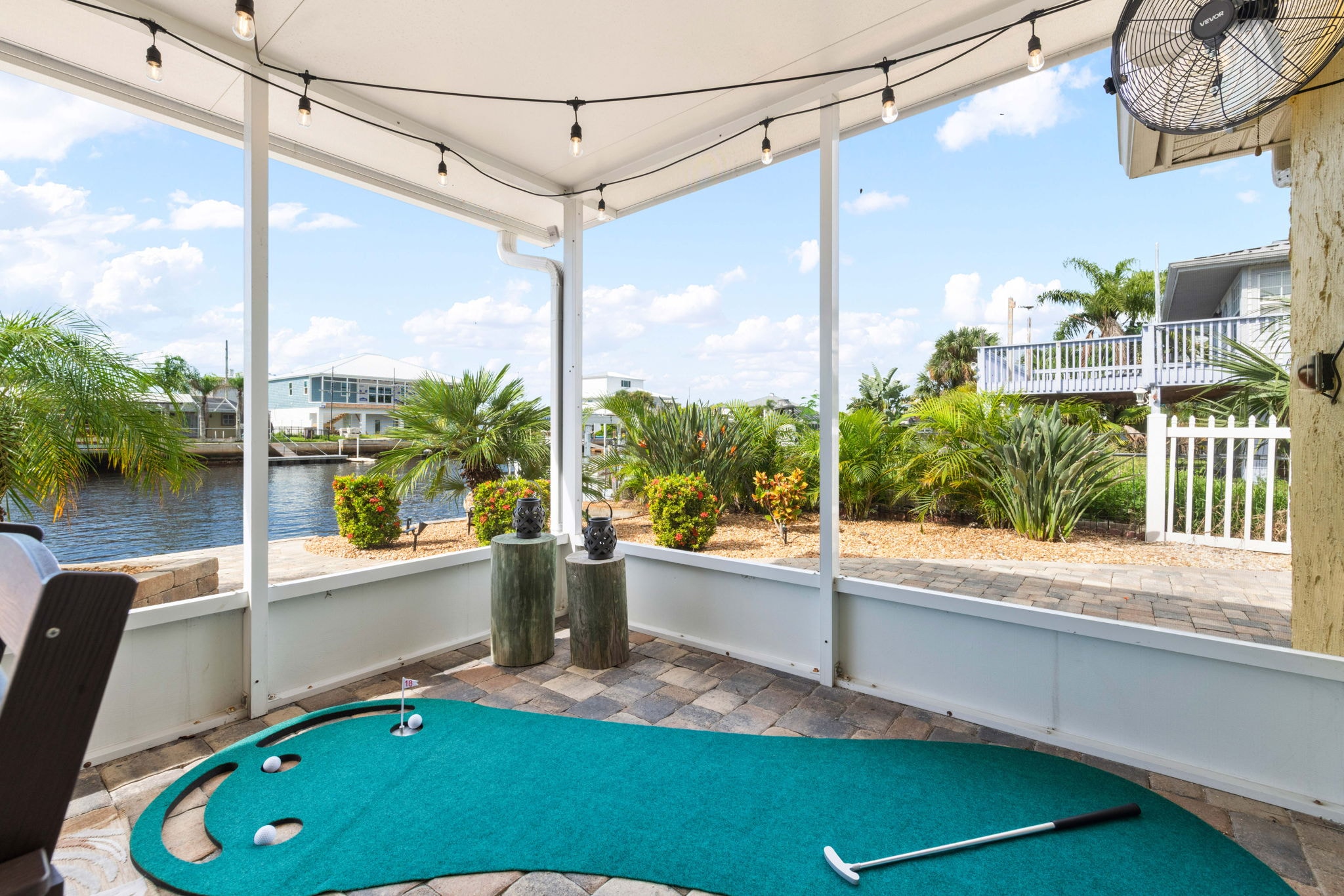 Screened lanai with canal views and wicker seating